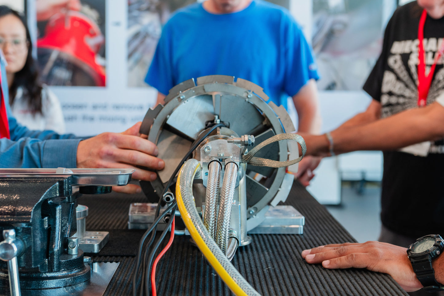 Person using a circular saw with others observing in a workshop setting